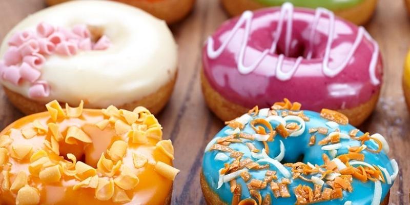 picture focused on four different flavors of donuts