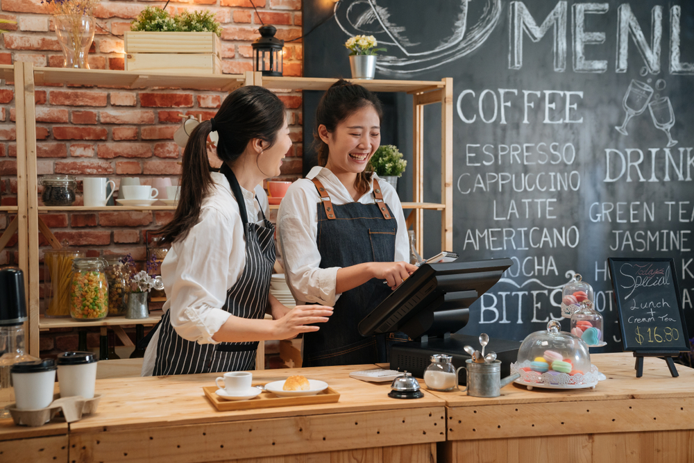 two female baristas talking