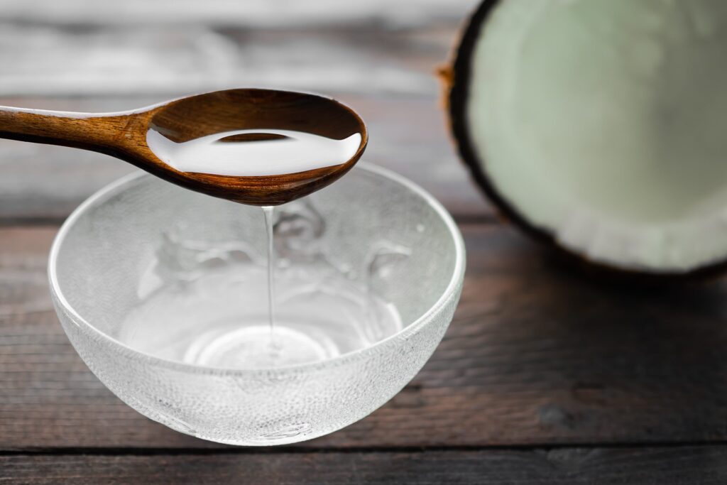 coconut oil being scooped in a bowl