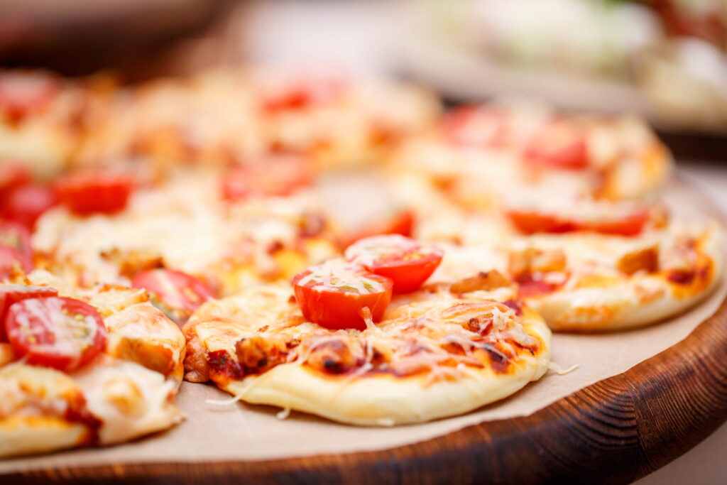 mini pizzas on a wooden plate
