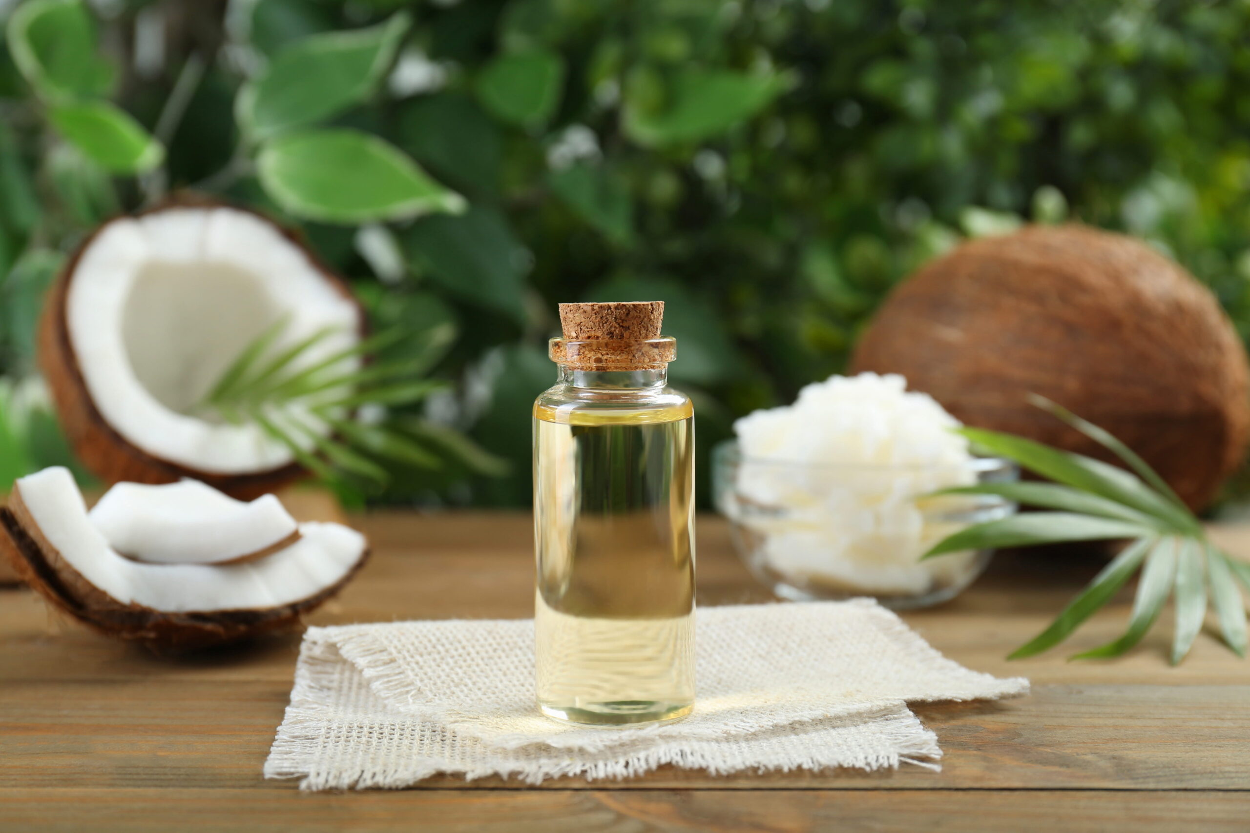 bottle of organic coconut cooking oil on wooden table