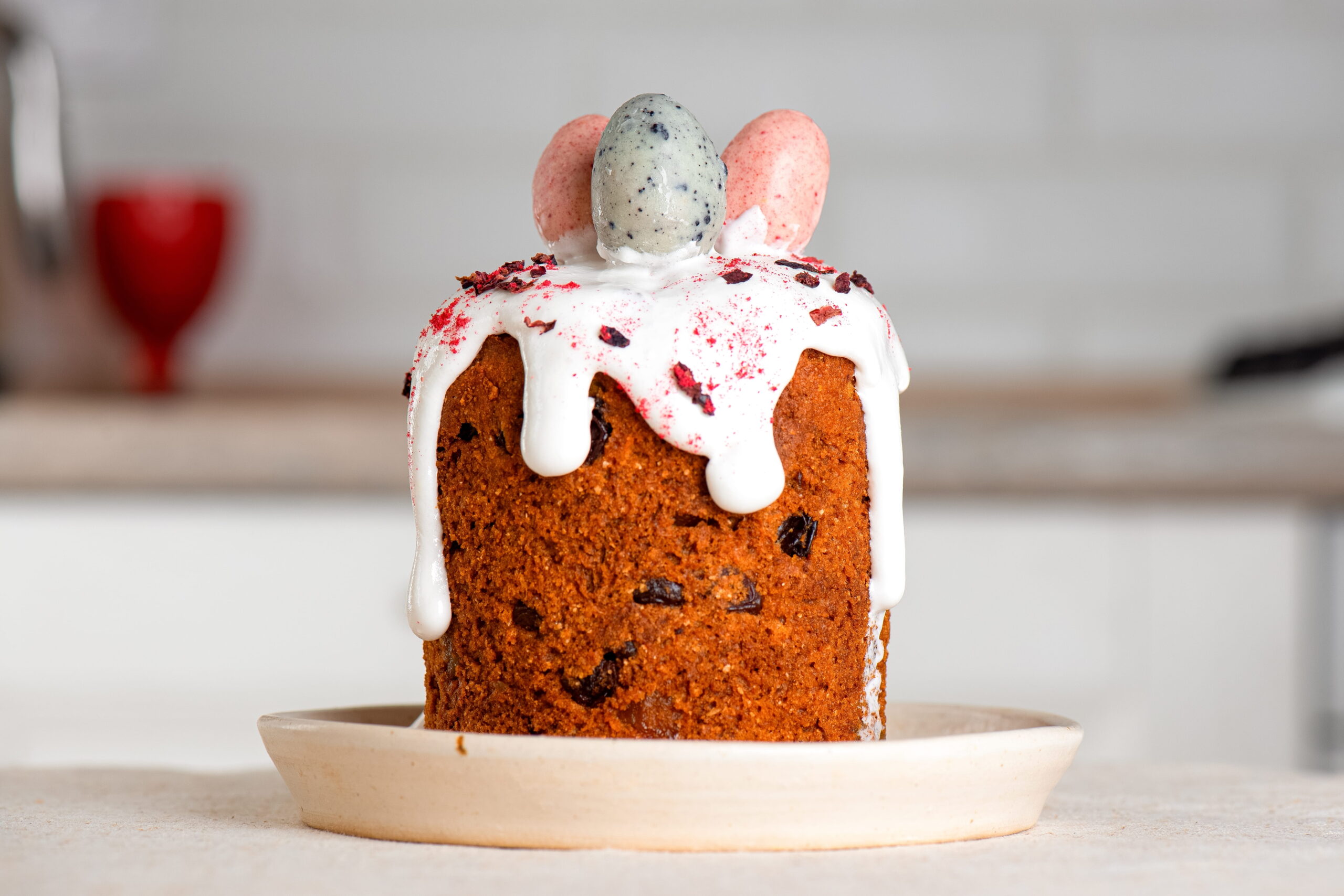 sweet bread decorated with white icing, marzipan eggs 